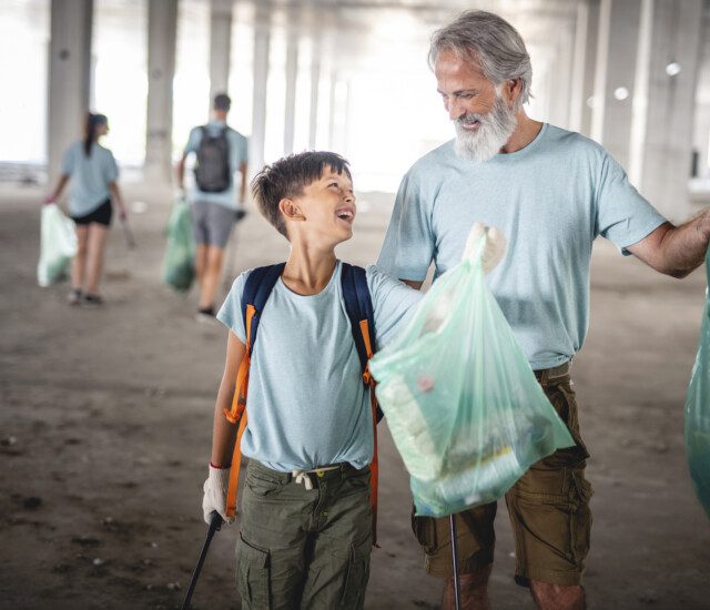 older man volunteering with a younger child