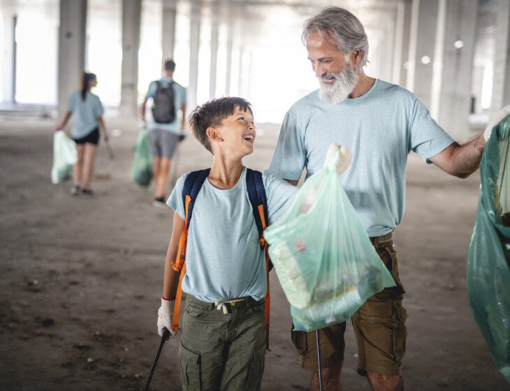 older man volunteering with a younger child